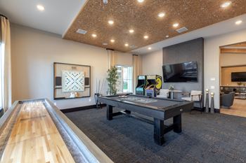 a game room with a pool table and a bowling alley